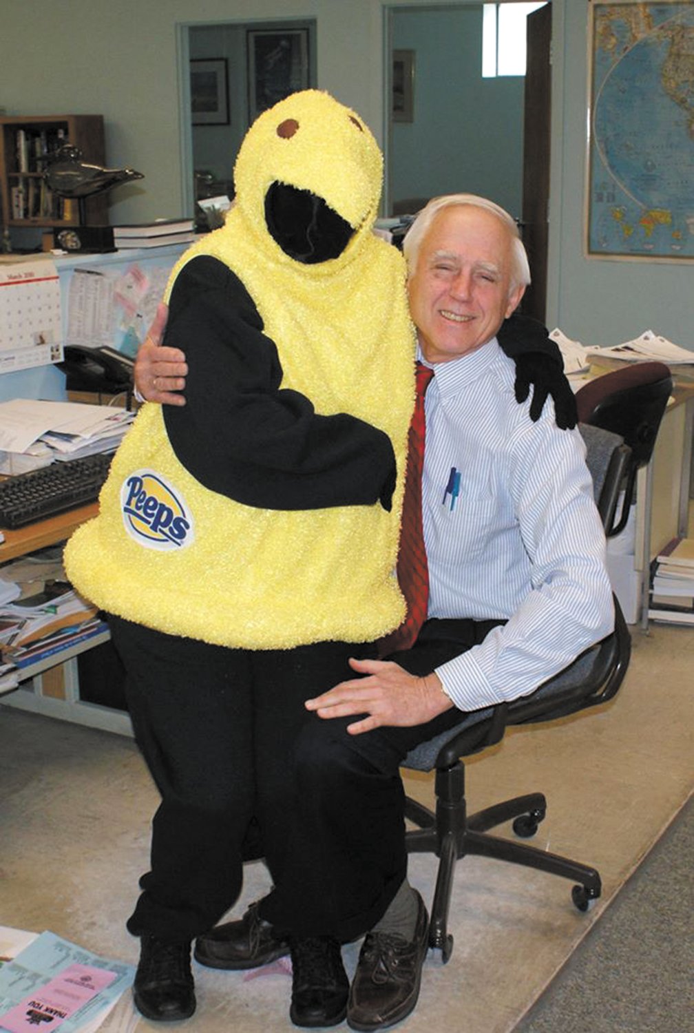 AND THEN SHE DRESSED AS A PEEP: After launching her “Peeps Show” with a giant-sized hand held Peeps, Meri notched it up with a Peeps outfit which she wore into the Beacon-Herald office. Here she shows it off to publisher John Howell.